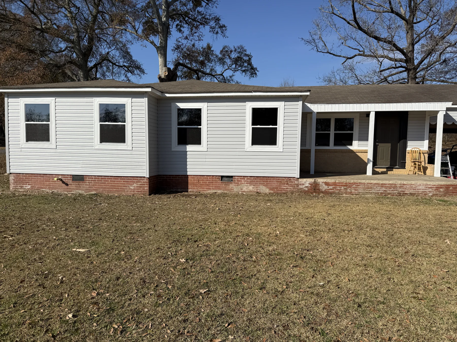 The same home after new windows and fresh light siding