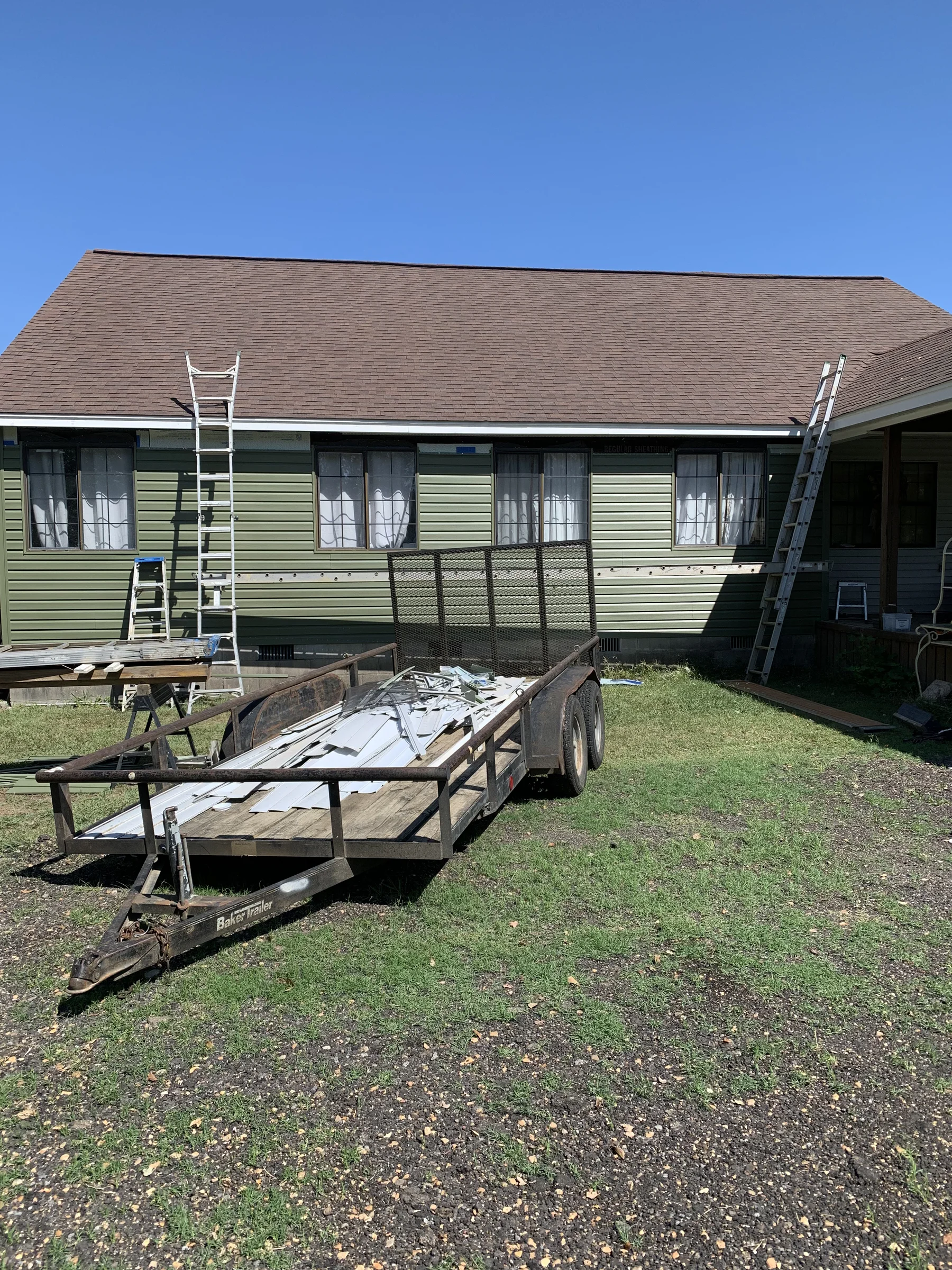 A dated home with worn green siding before Belk's work