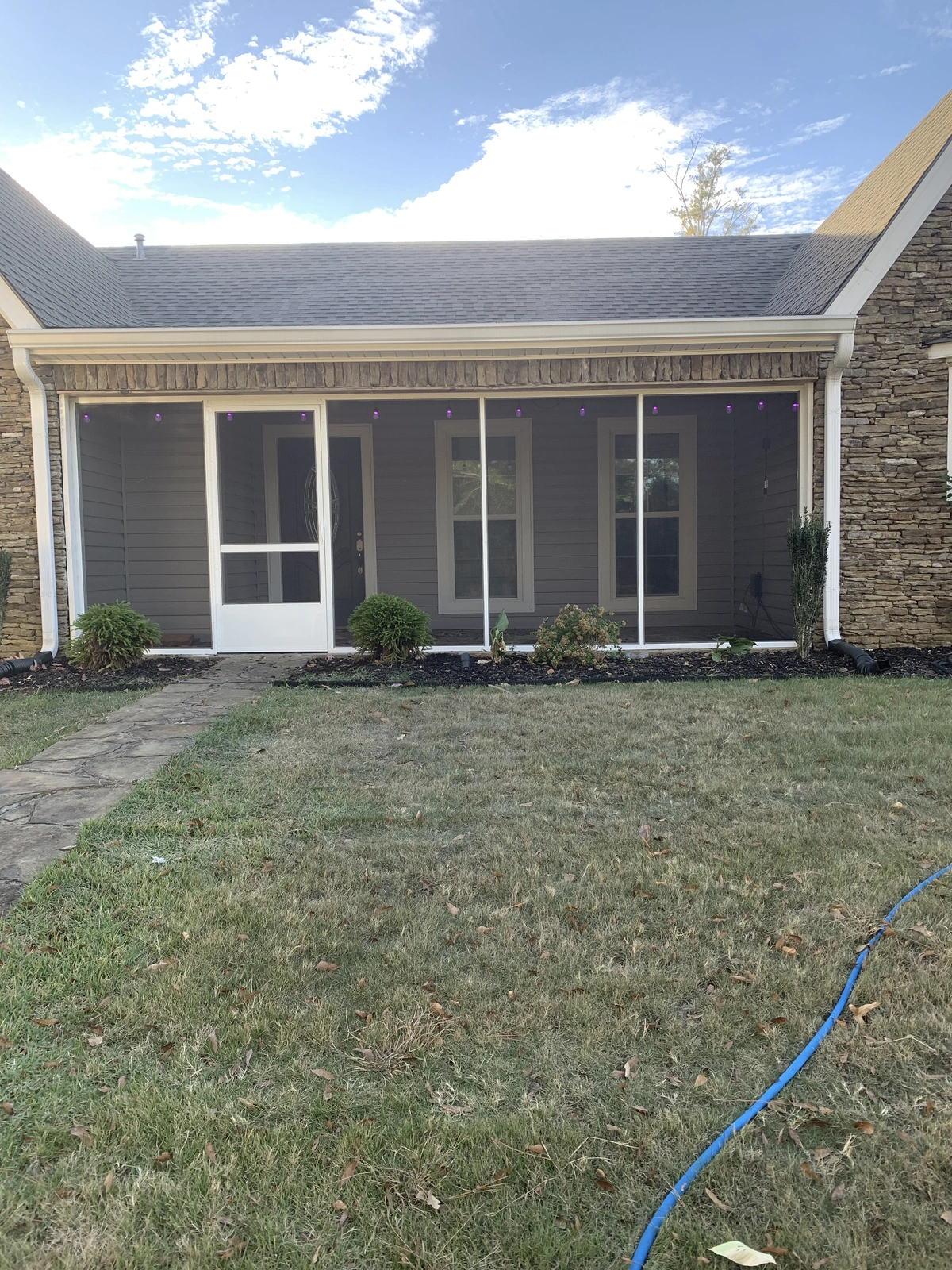 New windows and exterior work — for porch with stone exterior and grass