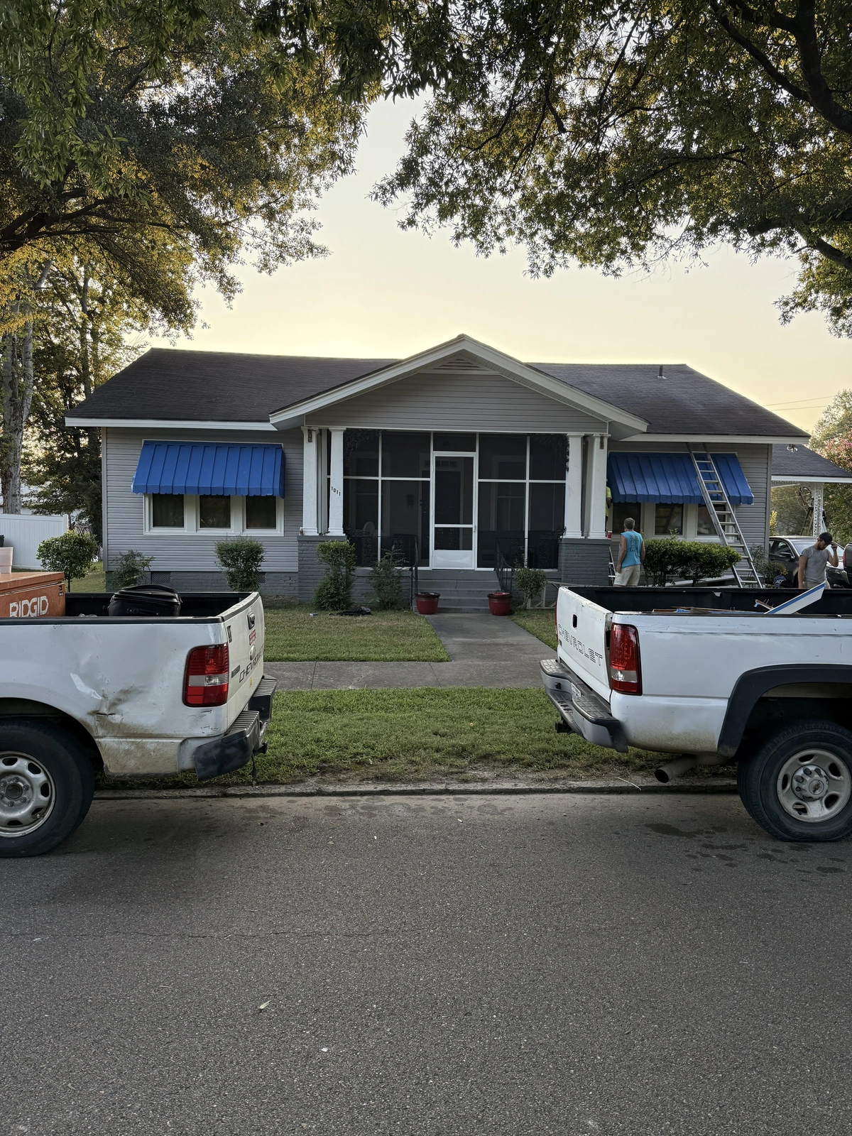 New windows and exterior work — front view house with trucks