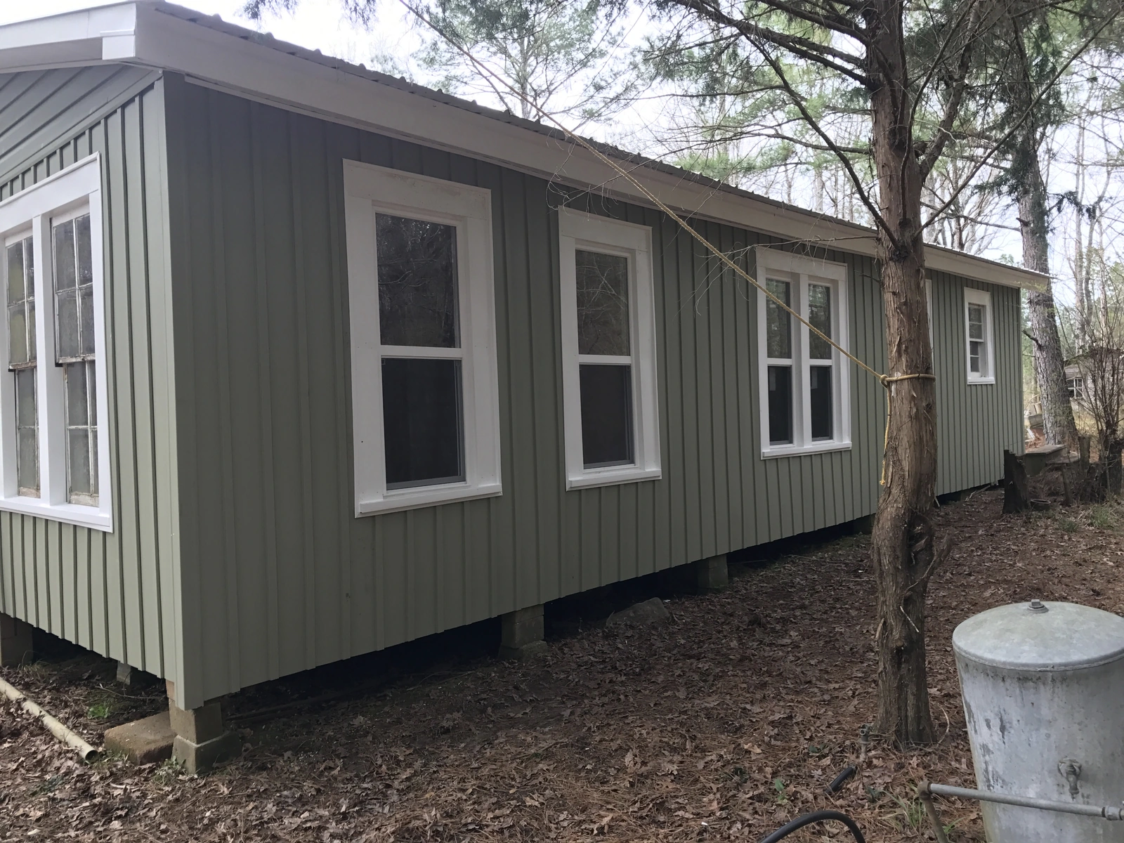 Clean new vinyl siding with three windows on a home exterior