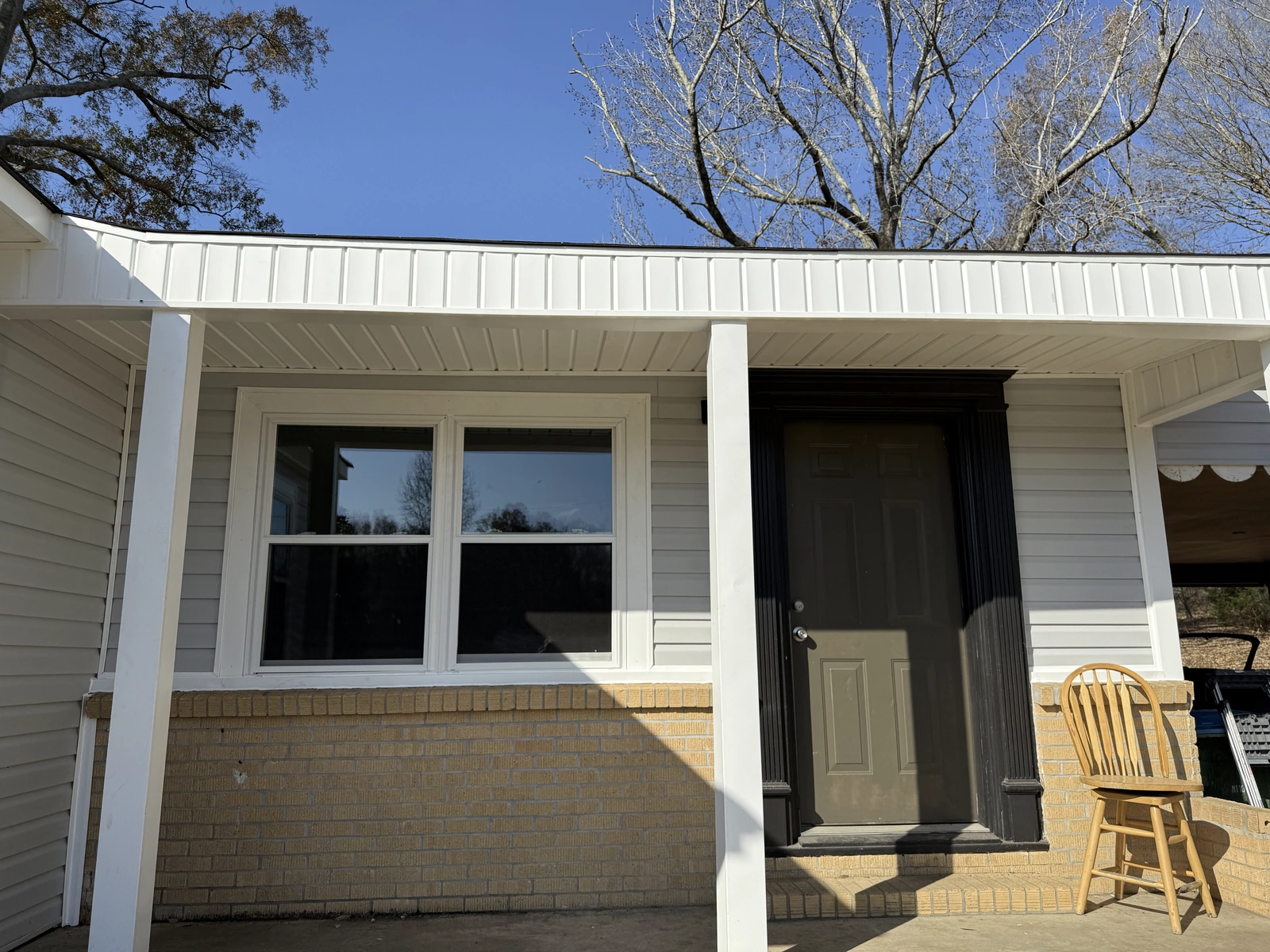 A home exterior with freshly installed replacement windows
