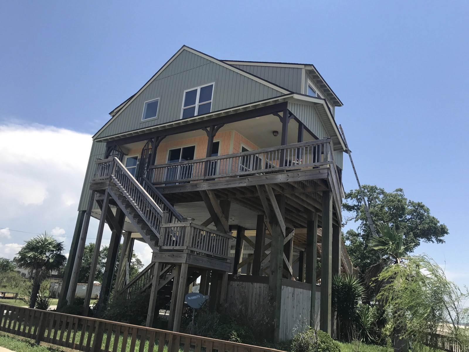 New windows and exterior work — modern house with wooden deck and steps