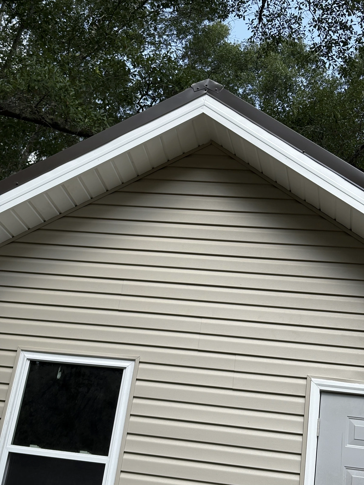 New windows and exterior work — siding and roof overhang view